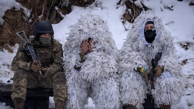 Members of the pro-Ukrainian Russian ethnic Siberian Battalion rest while training close to Kyiv on Wednesday. AP