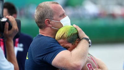 Gold medalist Ana Marcela Cunha of Team Brazil reacts with her coach after winning gold in the Women's 10km Marathon Swimming.