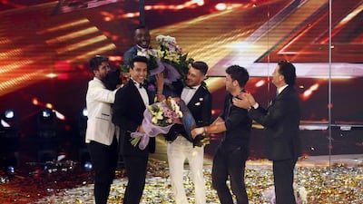 Boy band The 5 hold Hamza Hawsawi aloft after his win. Courtesy MBC