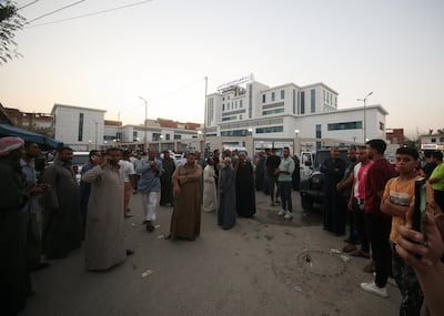 Families of victims wait to receive their bodies outside a hospital in Ismailia. Reuters