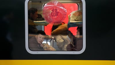 Travellers sit in a train at Beijing Railway Station in China. Reuters