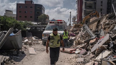 Civil defense workers in the aftermath of an Israeli airstrike in front of Jabal Amel Hospital in Tyre, Lebanon. Getty Images