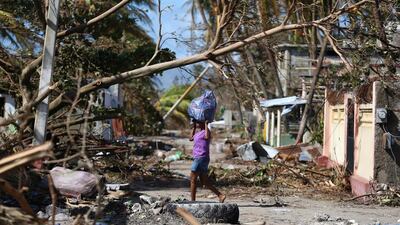 A woman walks through the rubble left by Hurricane Matthew in Playa Gelee, Haiti, on October 7, 2016. Orlando Barría/EPA