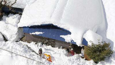 February's snowstorm in Japan inflicted $5.0 billion in economic losses, but only half of that figured was insured. Above, people remove snow in front of a house in Hayakawa of Yamanashi prefecture in Japan. Reuters / Kyodo