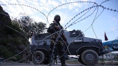 Indian security personnel stand guard on a deserted road during restrictions after scrapping of the special constitutional status for Kashmir by the Indian government. Reuters