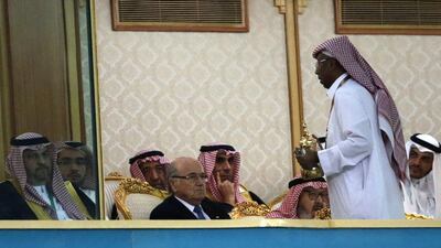 Fifa President Joseph Blatter (C) watches the opening match of the 22nd Gulf Cup football tournament between Saudi Arabia and Qatar at the King Fahd Stadium in Riyadh on November 13, 2014. Eight nations are taking part in the games including Oman, UAE, Kuwait, Yemen, Bahrain, Iraq, Saudi Arabia and Qatar. AFP PHOTO/KARIM SAHIB