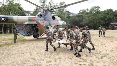 Army officers conducting a helicopter rescue of survivors. EPA