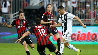 Ronaldo in action with AC Milan's Hakan Calhanoglu. Reuters