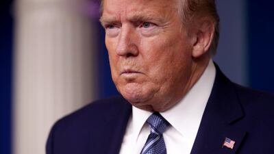 US President Donald Trump listens to a reporter’s question as he leads the daily coronavirus disease outbreak task force briefing at the White House in Washington. Reuters