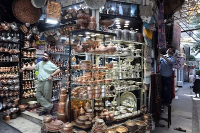 Shopkeepers wait for customers at a bazaar in northern Tehran. EPA