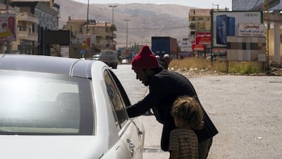 In Lebanon, Syrian refugees who escaped the war are now affected by the currency crisis and struggle to survive, with many resorting to begging for money on the street. Thibault Lefébure for The National