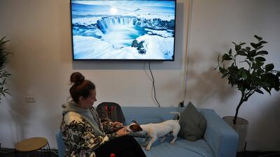 A Ukrainian refugee who fled the Russian invasion of her country sits with her pet at a holiday village turned into temporary refuge in Goren, northern Israel. AFP