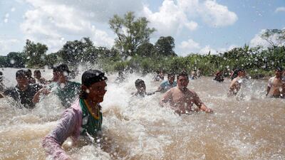 Migrants react after crossing the Suchiate river, a natural border between Guatemala and Mexico. Reuters