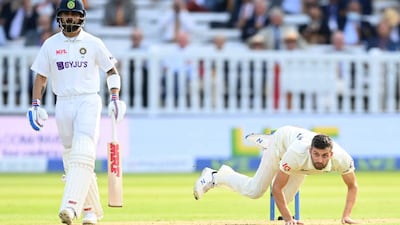Mark Wood of England falls over after bowling during the opening day of the Lord's Test.