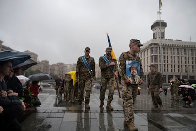 Ukrainian troops carry the coffin of a fallen serviceman in Kyiv's Independence Square. AP