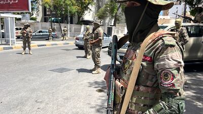 Libyan security forces stand guard at a checkpoint following overnight clashes in Tripoli. EPA