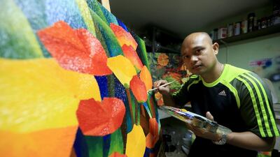A sheikha once offered Elmer Ducay Dh9,000 for some of his paintings. “By doing the things I love, I earn money,” he says. Ravindranath K / The National