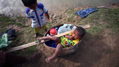 Kobir, 2, a Rohingya refugee boy waits for permission from border guards to continue his way after crossing from Myanmar into Palong Khali, near Cox's Bazar, Bangladesh. Hannah McKay / Reuters