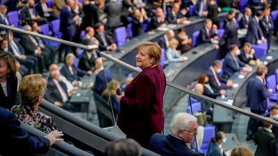 Departing Chancellor Angela Merkel takes her seat in the public gallery of the German parliament. AP