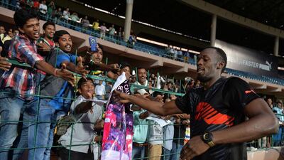 Usain Bolt greets fans in Bangalore during his cricket and sprint exhibition on Tuesday. Manjunath Kiran / AFP