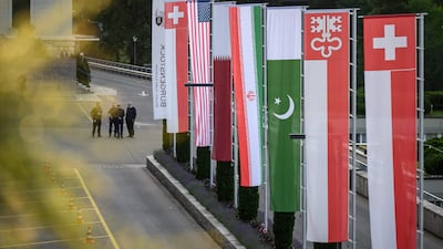 Flags fly at the Burgenstock luxury hotel complex overlooking Lake Lucerne in Switzerland yesterday ahead of high-level talks aimed at advancing a deal to end the Middle East conflict. AFP