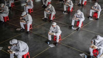 Employees eating during lunch break at an auto plant of Dongfeng Honda in Wuhan in China's central Hubei province. AFP