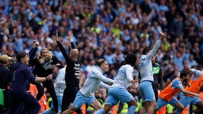 Manchester City coach Pep Guardiola and his team celebrate after winning the Premier League. AP