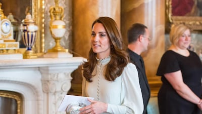 The Duchess of Cambridge wears a light blue dress, designed for the royal by a private dressmaker, according to Kensington Palace, for a reception marking the 50th anniversary of the investiture of the Prince of Wales at Buckingham Palace on March 5. The bespoke dress was worn with off-white Emmy London heels and an Alexander McQueen clutch. Getty Images