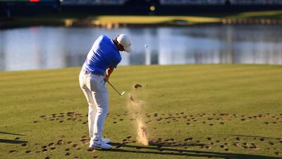 McIlroy of Northern Ireland plays his shot from the 17th tee. AFP