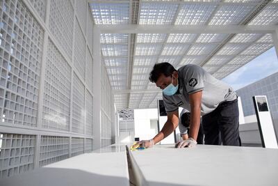 A worker cleans outside Louvre Abu Dhabi after it was announced it would be closed amid the ongoing coronavirus pandemic. EPA / Mahmoud Khaled