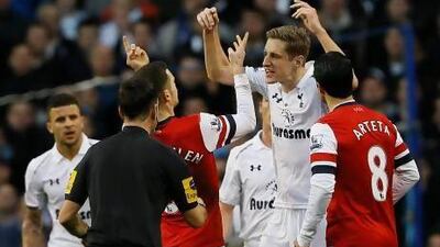 Michael Dawson, second right, the Tottenham captain, argues with Arsenal's Thomas Vermaelen, third left. Kirsty Wigglesworth / AP Photo