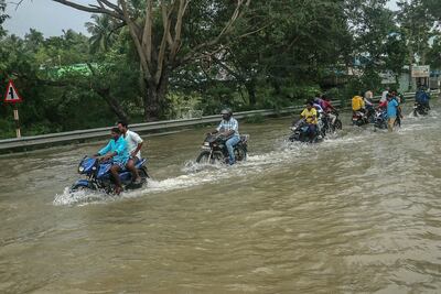 Motorists move through a flooded street after heavy rainfall in Cuddalore on December 2. AFP