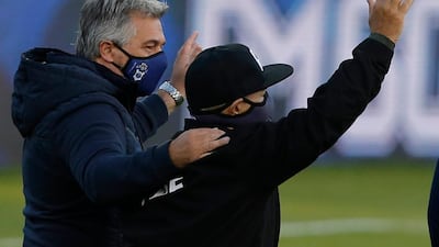 Argentina's Gimnasia y Esgrima La Plata coach Maradona waves before the start of a first division match against Patronato in La Plata, Buenos Aires, on his 60th birthday. AFP