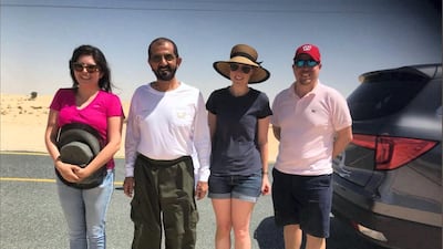 Hanna Karen Arroyo thanked the Ruler of Dubai after he helped to tow her car out of the sand off a desert road on Saturday. She shared this image of her and her friends with Sheikh Mohammed on Twitter. Courtesy: Hanna Karen Arroyo / Twitter