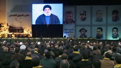 Hassan Nasrallah, the head of Lebanon’s militant Shiite Muslim movement Hizbollah, addresses supporters through a giant screen on January 30, 2014. Joseph Eid / AFP