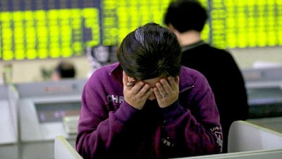 More than 30 per cent has been knocked off the value of Chinese shares since mid-June. Above, a retail investor rubs her face as she stands at a computer terminal in a brokerage house. Chinatopix via AP