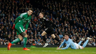Leicester City's Jamie Vardy, centre, celebrates scoring against Manchester City as defender Aymeric Laporte, right, and goalkeeper Ederson look on. Manchester City went on to win the game 5-1. Andrew Yates / Reuters