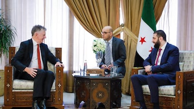 Britain's National Security Adviser Jonathan Powell, left, with Syria's President Ahmad Al Shara in Damascus on August 5, 2025. AFP