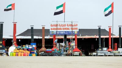 Portable fireplaces for desert camps, wood, camel bling and hairspray for camel beauty pageants are sold on Millions Street at the Al Dhafra Festival, Abu Dhabi. Victor Besa / The National