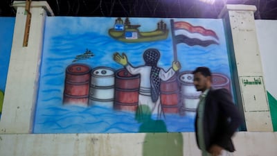 A person passes a mural depicting a Houthi fighter holding a Yemeni flag while stopping US and Israeli ships, in Sanaa, Yemen, last Sunday. EPA