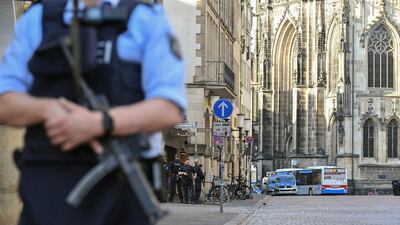 An armed policeman stands guard at the attack site in Munster. Sascha Steinbach / EPA