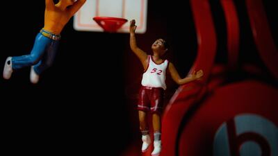 Men play basketball on a tiny court near Beats by Dre headphones. Courtesy Omar Maree Humaid