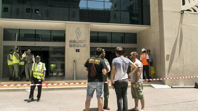 Residents of Dubai Marina's Torch tower talk to a police officer on Friday. Reem Mohammed / The National.