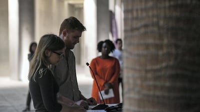 Katie Glasgow-Palmer and Thomas Yates, both NYUAD students from New Zealand, speak at the candlelight vigil on Monday. Khushnum Bhandari for The National