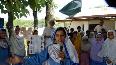 Hindko speaking schoolchildren sing the national anthem at their school in Mansehra., Pakistan on August 30,2016 Farooo Naeem / AFP