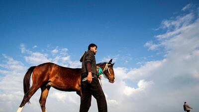 A Palestinian walks with his horse along a beach in Gaza City. AFP