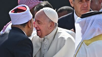 Pope Francis (C) embraces Bahrain's Grand Imam of al-Azhar mosque Sheikh Ahmed Al-Tayeb as King Hamad bin Isa al-Khalifa (R) looks on during a ceremony at Sakhir Royal Palace. AFP