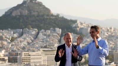 German Chancellor Olaf Scholz, left, and Greek Prime Minister Kyriakos Mitsotakis visit the landmarks of ancient Athens. AP
