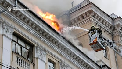 Rescuers tackle a blaze at a building struck by Russian bombs, in Dnipro. AP
