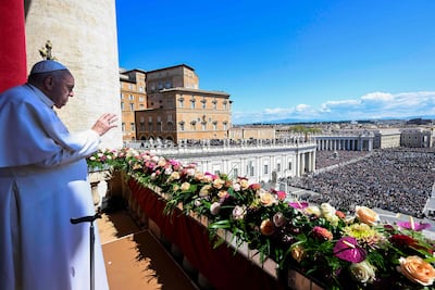 Pope Francis waves to the crowd in St Peter's square after delivering the Urbi et Orbi message and blessing for Easter. Vatican Media / AFP